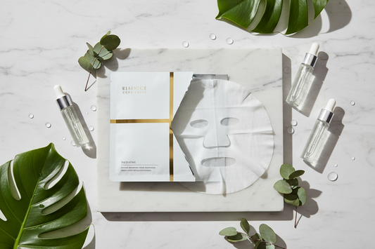 Premium sheet mask on marble surface with skincare essentials in minimalist spa setting